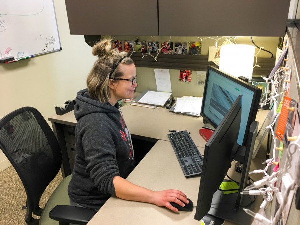 Woman working at computer in a cubicle