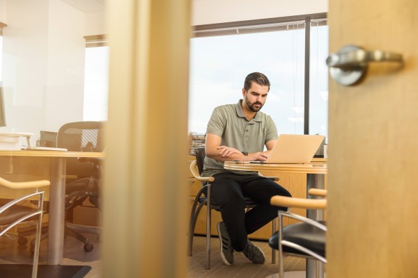 Image of a man working on this laptop.