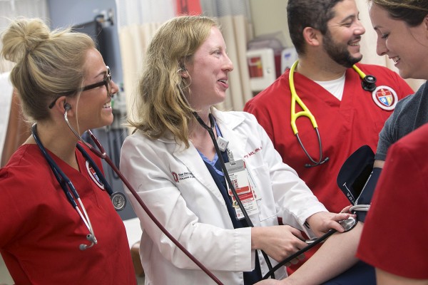 Ohio State students practice taking a patient's blood pressure