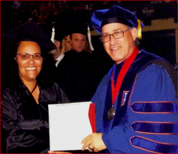 Winnie Sampson accepting her degree from her supervisor Dr. Tomasko at Ohio State