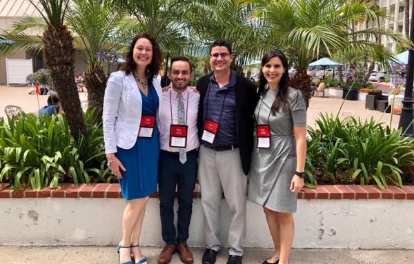 Four educators from the Department of Spanish and Portuguese stand together outside.