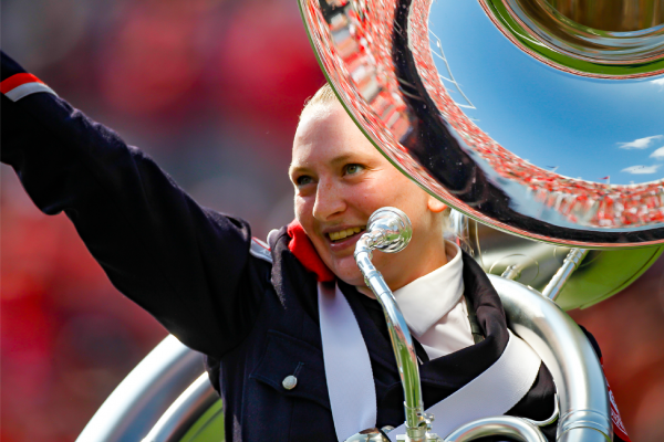 Lindsay Hosteler holds her sousaphone and gestures to the crowd during an Ohio State football game