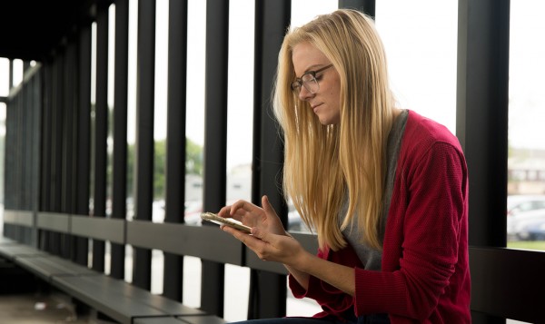 Woman with smartphone sitting