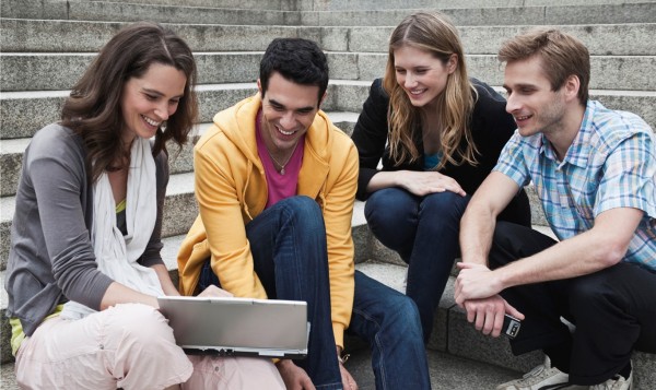 decorative image of people gathered around laptop