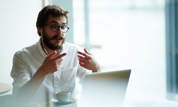 decorative image man gesturing at laptop