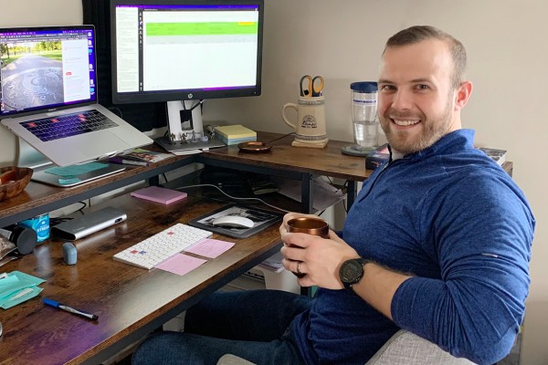 Todd Thomas sits at a computer desk in his home office