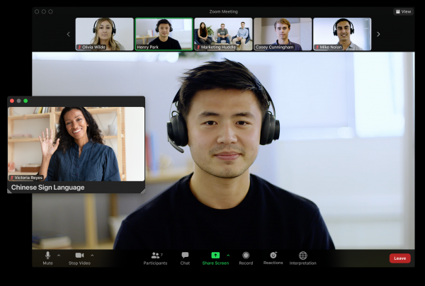 A Zoom meeting with several participants, including a separate window for a sign language interpreter