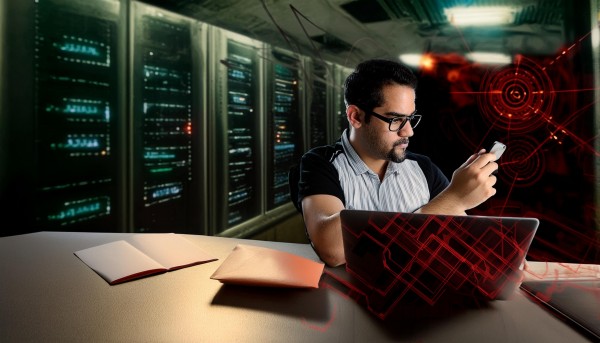 decorative image of a male technician working on a laptop