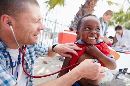 student provides check-up in service learning experience