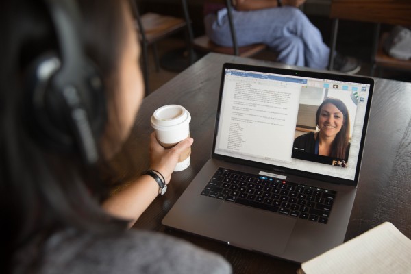 Woman working on her laptop at a coffee shop.