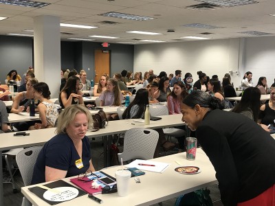 Rows of students sitting in a classroom for orientation